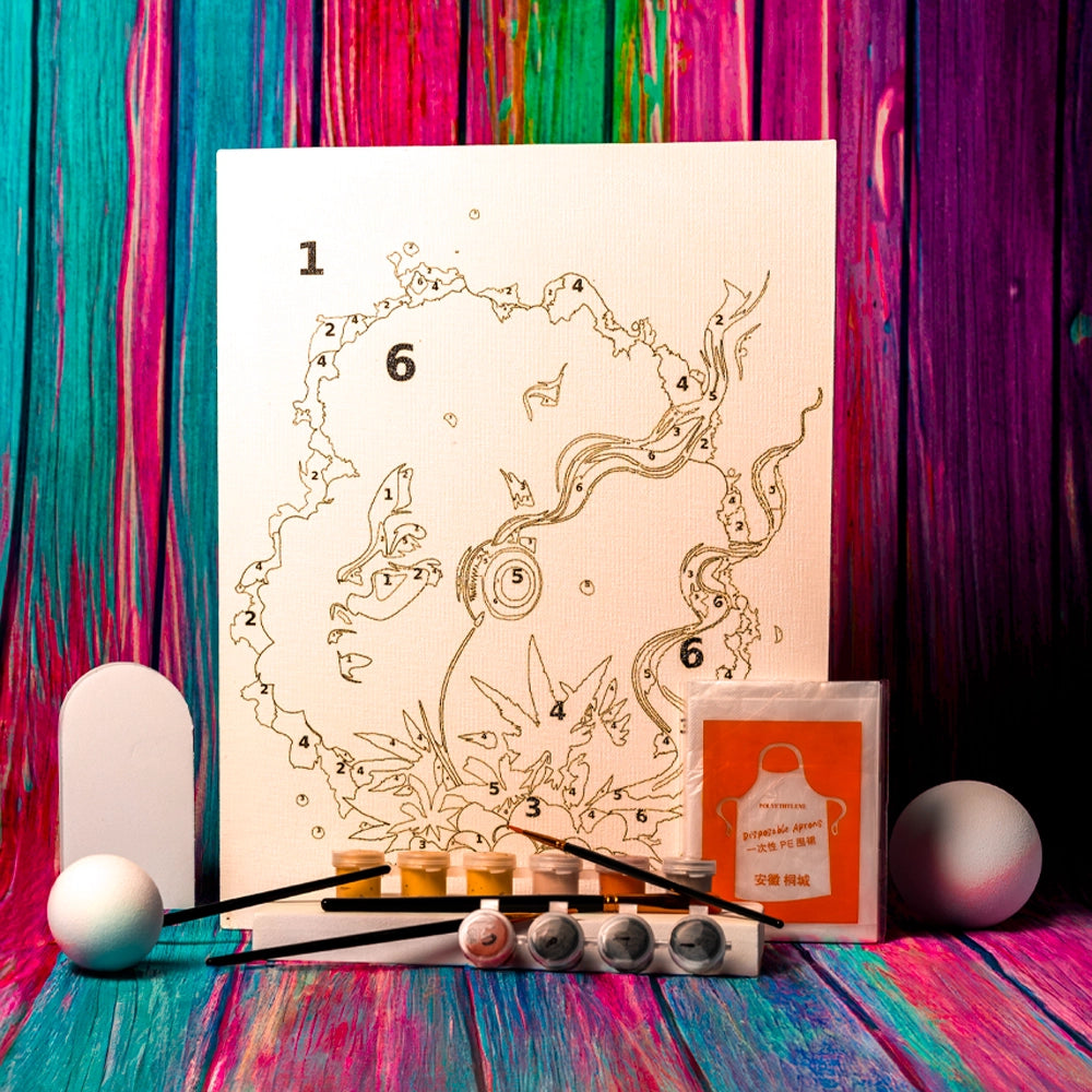 A Puff Pass Print Watercolor Paint by Numbers Cannabis Painting Kit is displayed. The kit features a canvas with a numbered outline of a woman's profile, accented with cannabis leaves and abstract designs. Included in the kit are paint pots in various colors, paintbrushes, and a disposable apron. The items are arranged neatly against a vibrant background of wooden panels in pink, blue, and purple hues, enhancing the creative and lively presentation of the painting kit.